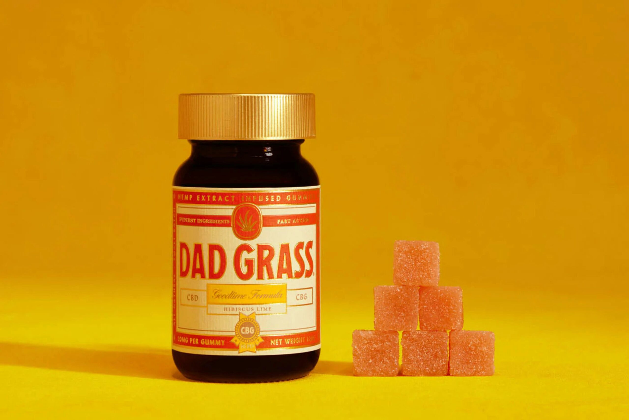 a bottle of dad grass next to a pile of sugar cubes